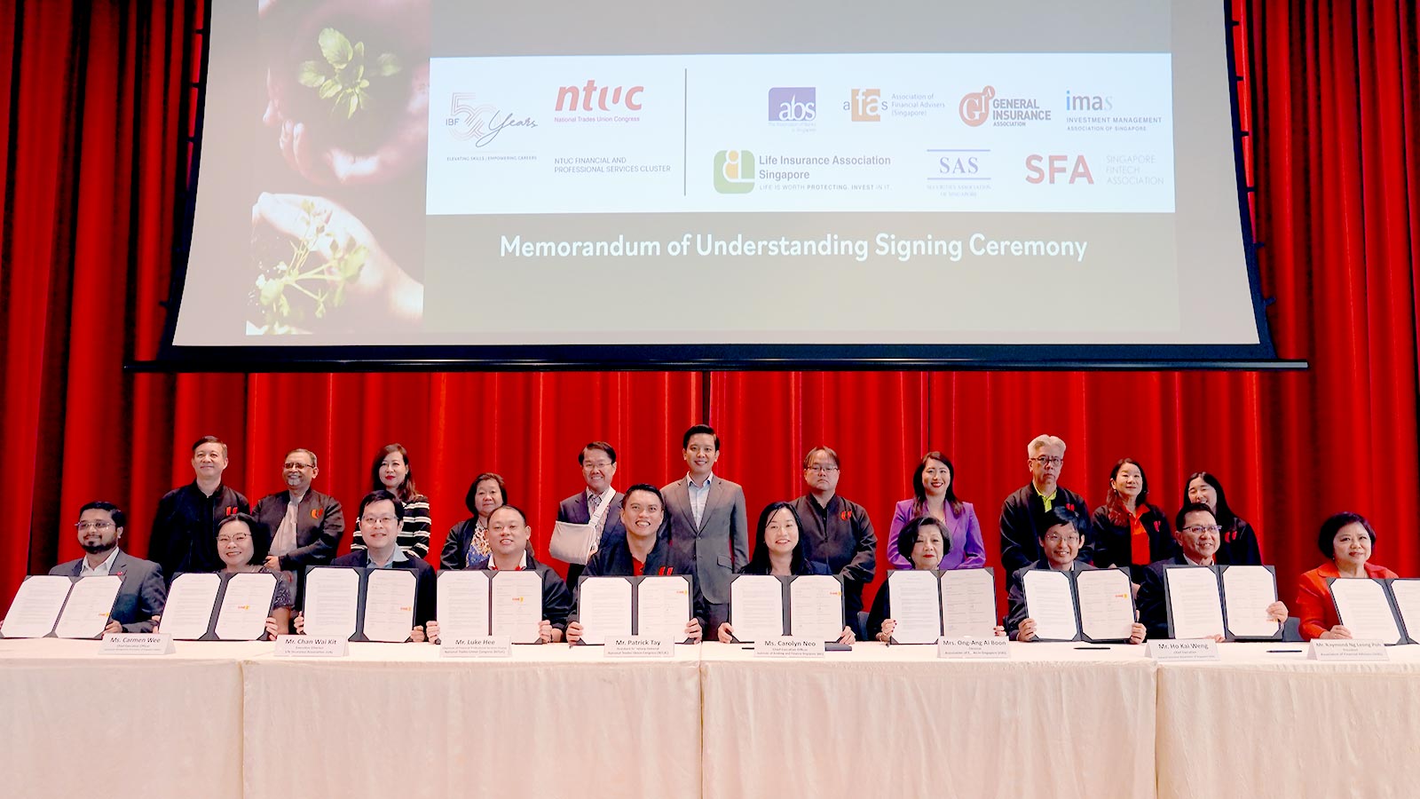 Signing of Memorandum of Understanding between IBF, NTUC and 7 financial sector associations, witnessed by Minister of State, Alvin Tan.