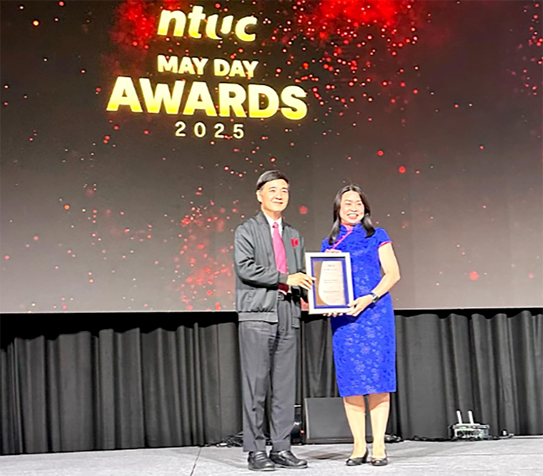 IBF CEO, Carolyn Neo, receiving the Partner of Labour Movement Award from NTUC Deputy Secretary-General, Heng Chee How.
